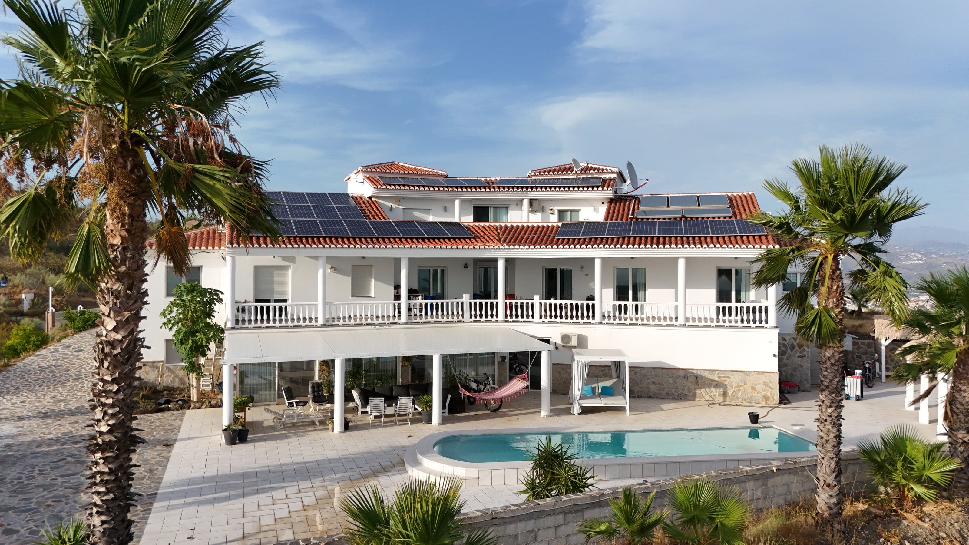 Aerial view of the villa framed by palm trees