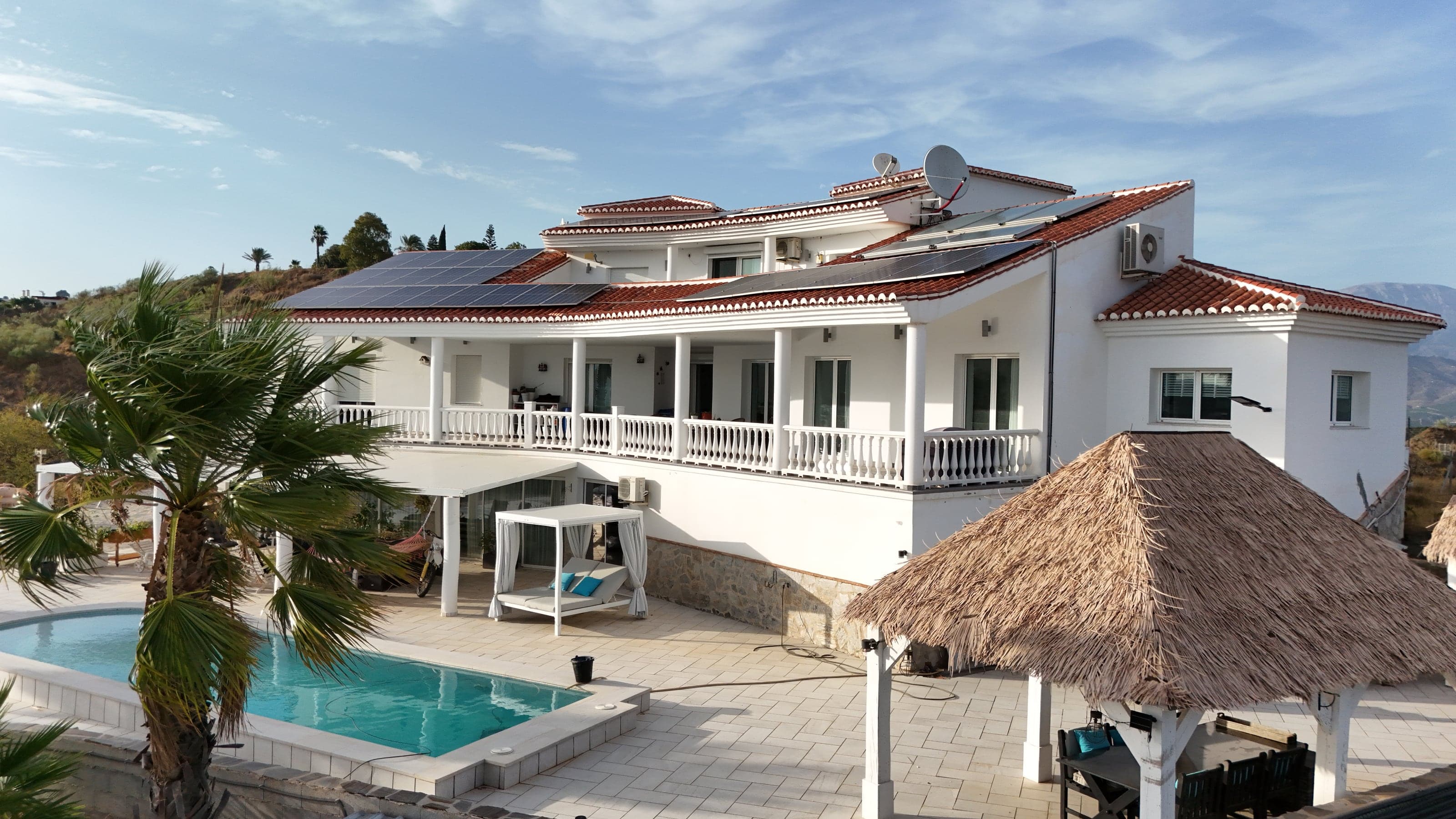 Aerial view of the villa and pool at dusk