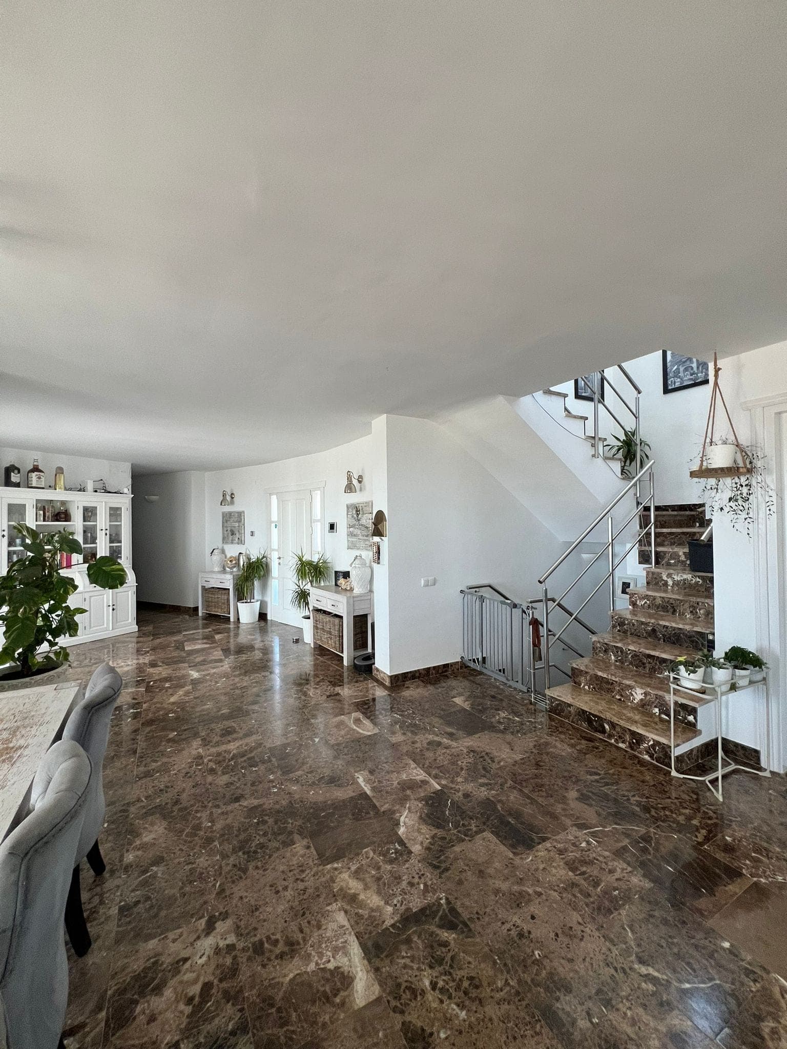 Living room with marble flooring and garden views